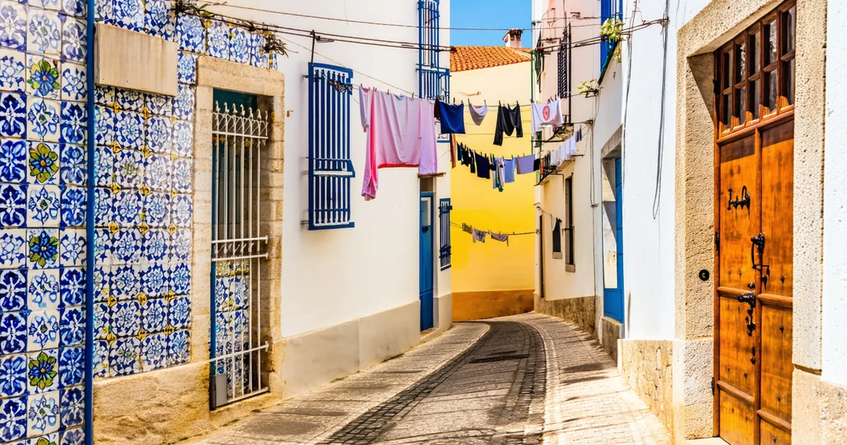 Quiet Lisbon street in Alfama neighborhood with colorful tiles and morning light